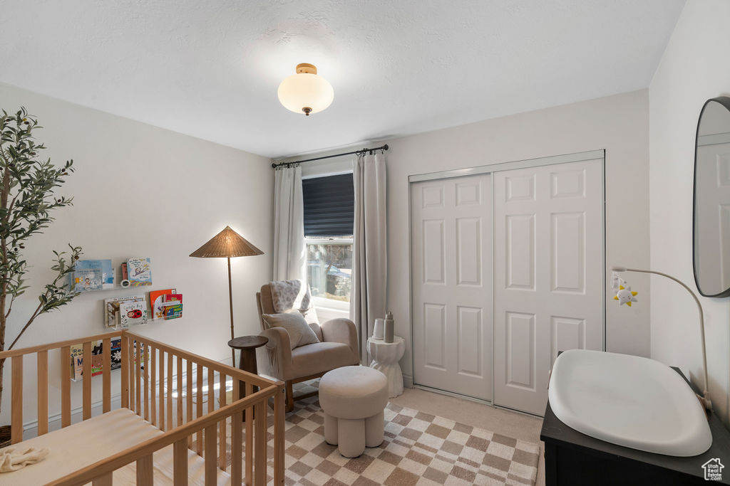 Bedroom with a closet and a crib