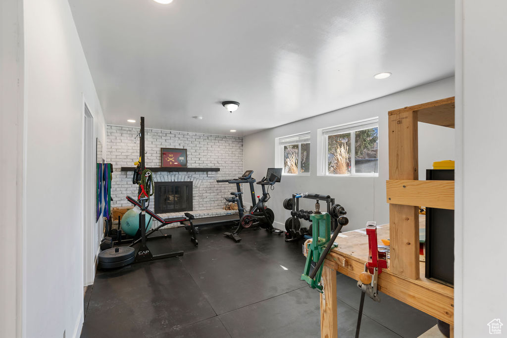 Workout room featuring a brick fireplace and recessed lighting