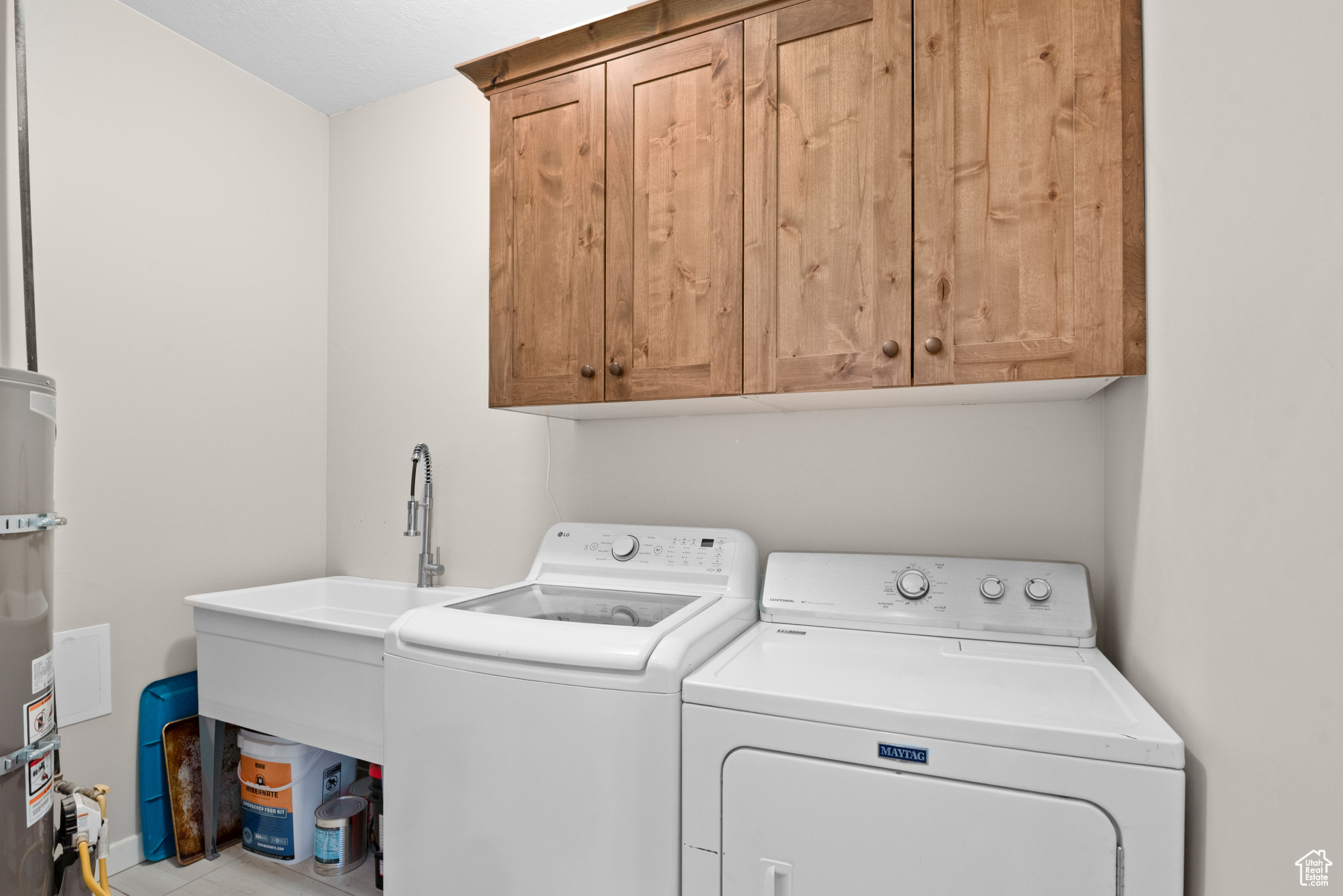 Washroom featuring cabinet space and independent washer and dryer