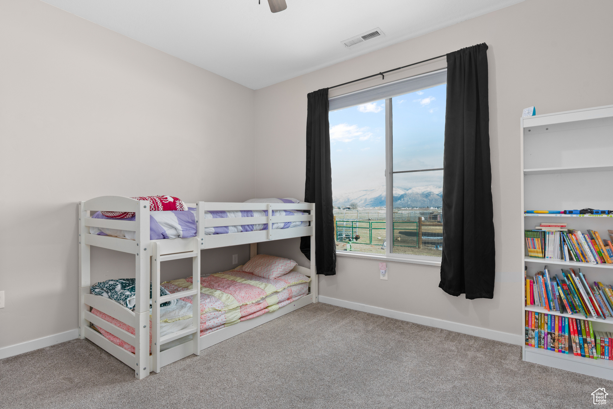 Bedroom featuring a ceiling fan, baseboards, visible vents, and carpet flooring