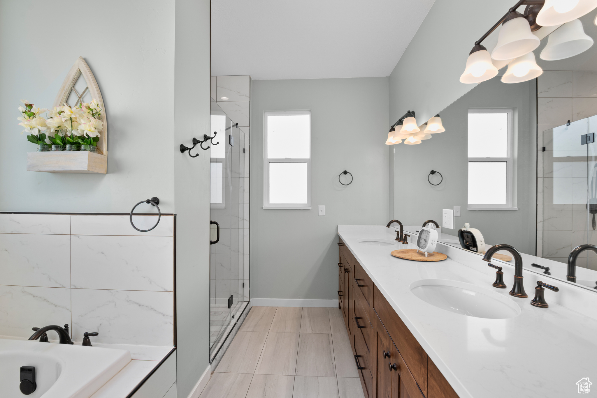 Full bath featuring plenty of natural light, a sink, and a shower stall