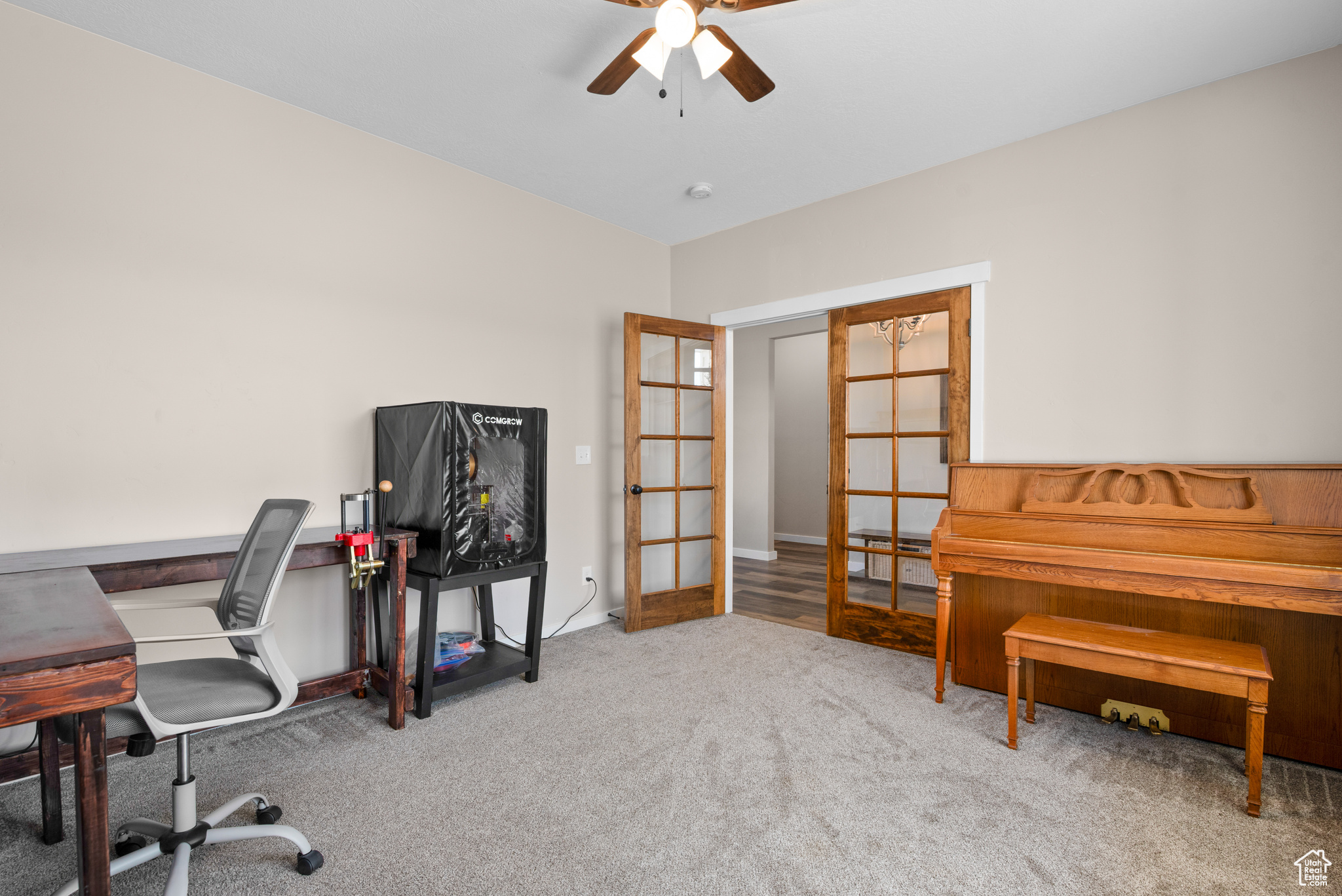 Office with french doors, carpet, and a ceiling fan