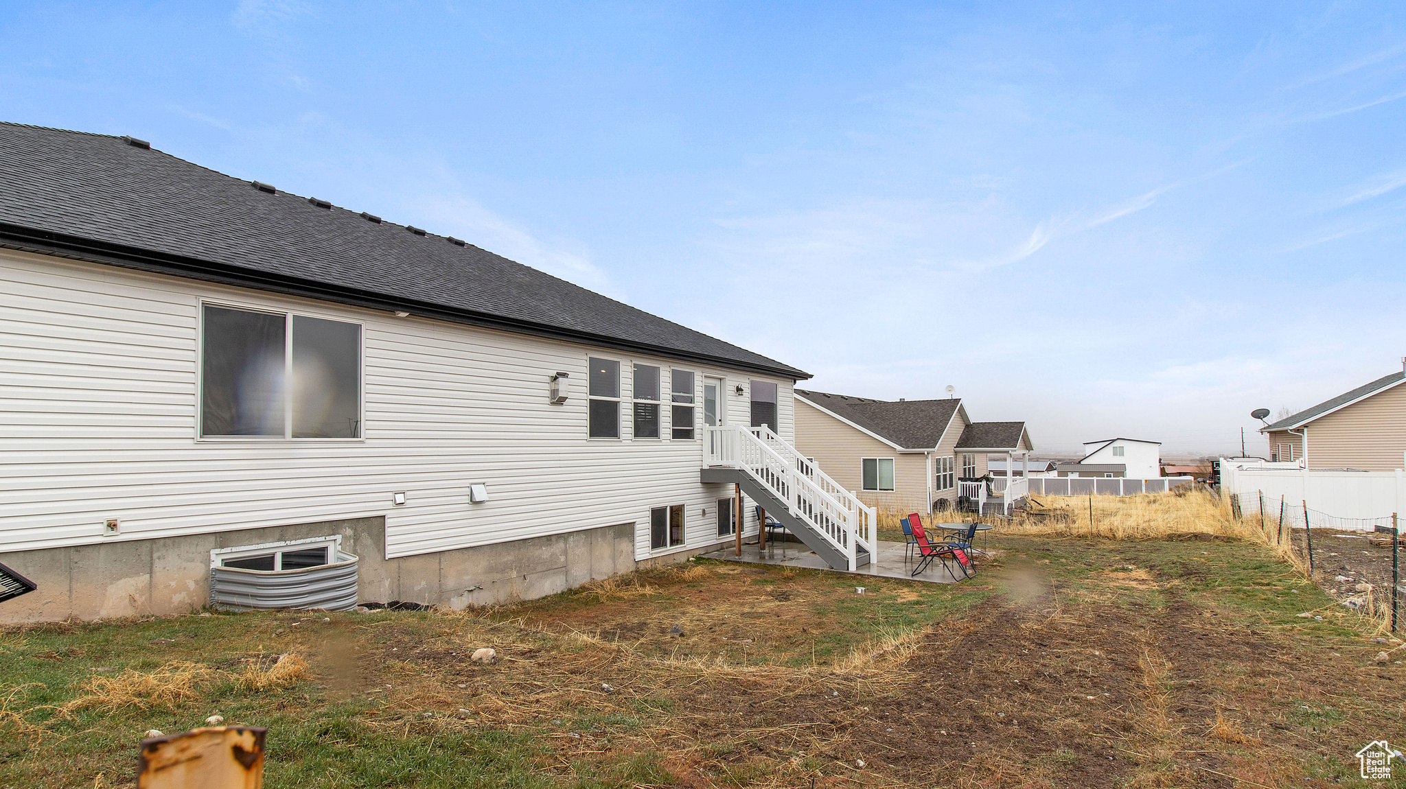 Back of property featuring a shingled roof and fence