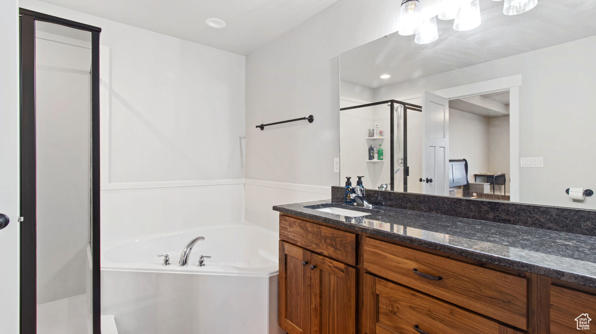 Bathroom with vanity, a garden tub, and a shower stall