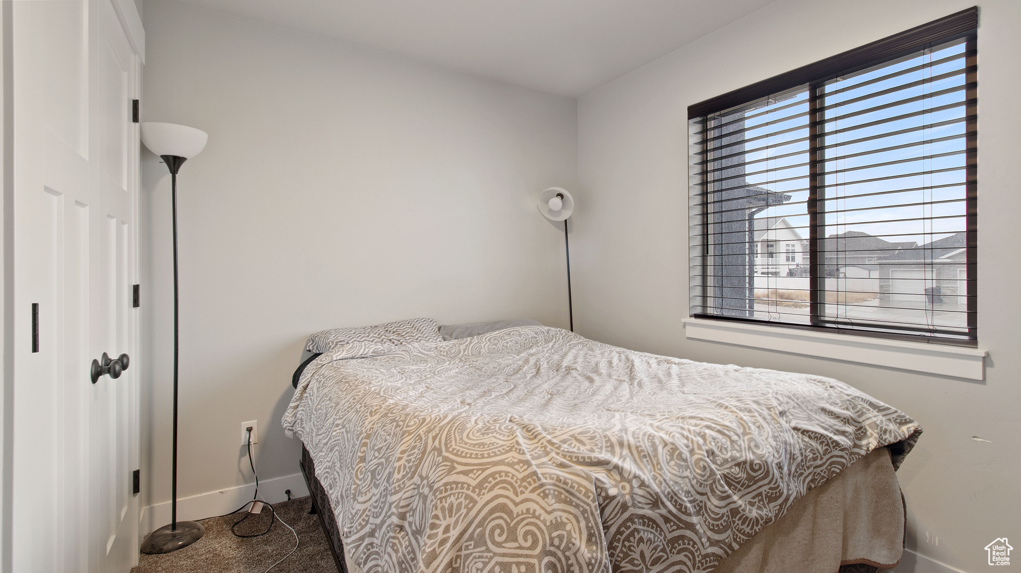 Bedroom with carpet flooring and baseboards