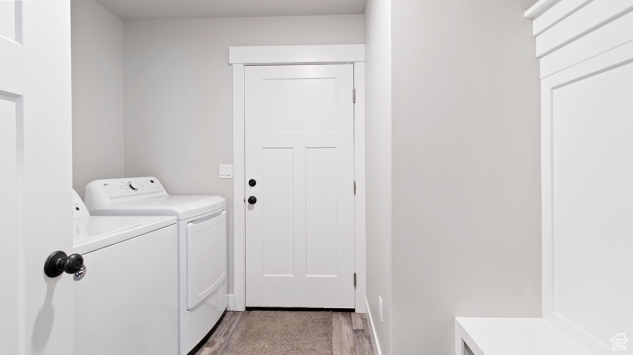 Washroom featuring light wood-style floors, separate washer and dryer, and laundry area