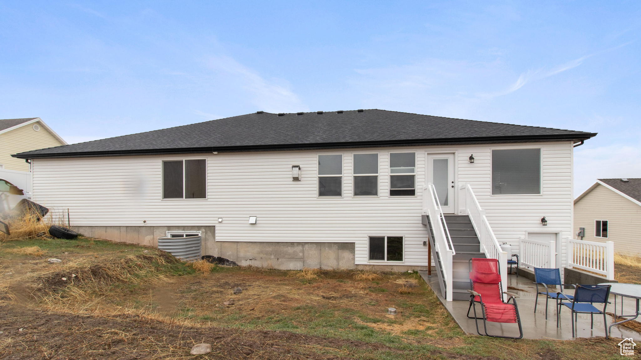 Back of house featuring roof with shingles