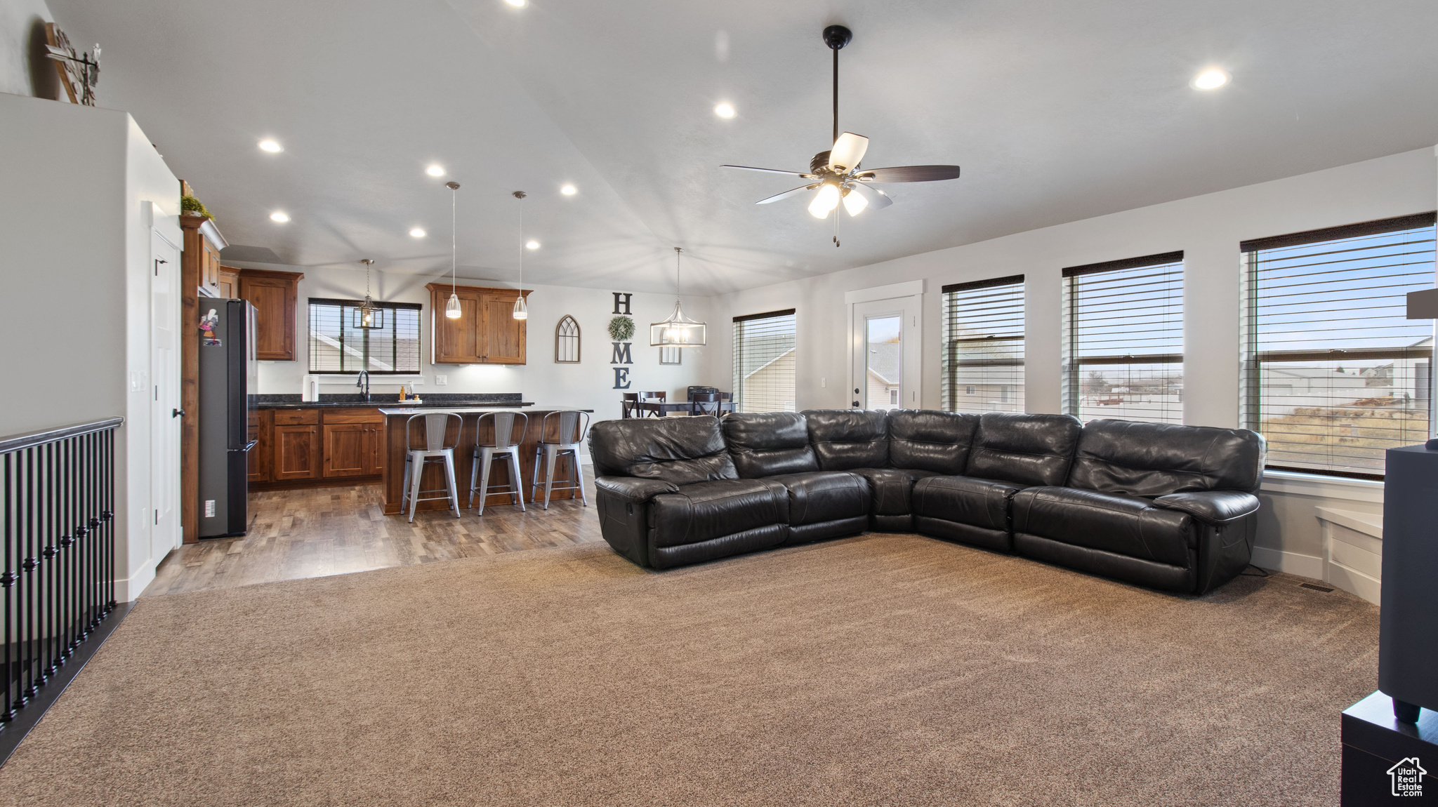 Living room featuring carpet, recessed lighting, and a healthy amount of sunlight