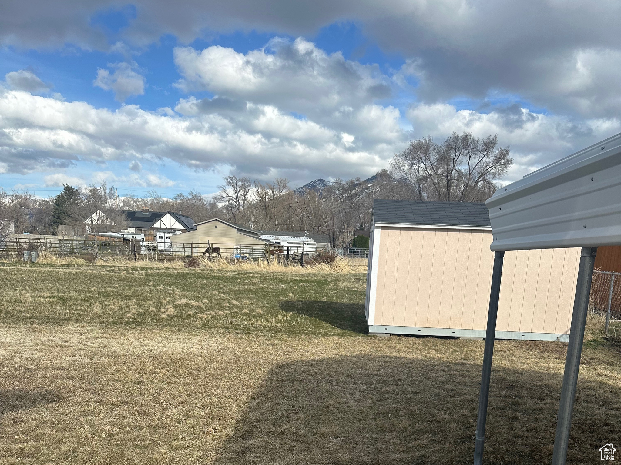 View of yard with an outbuilding and a shed