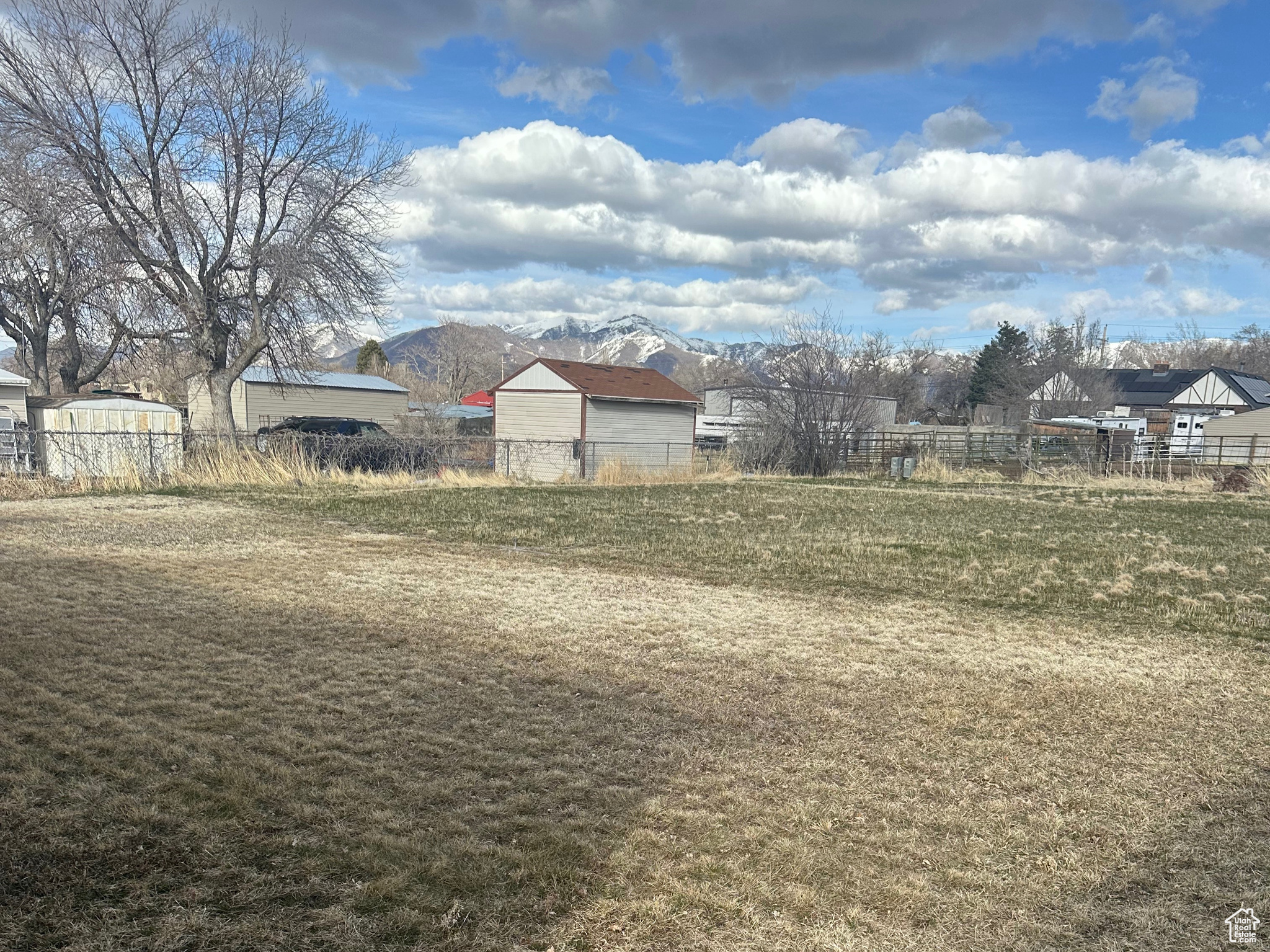 View of yard featuring a mountain view and fence