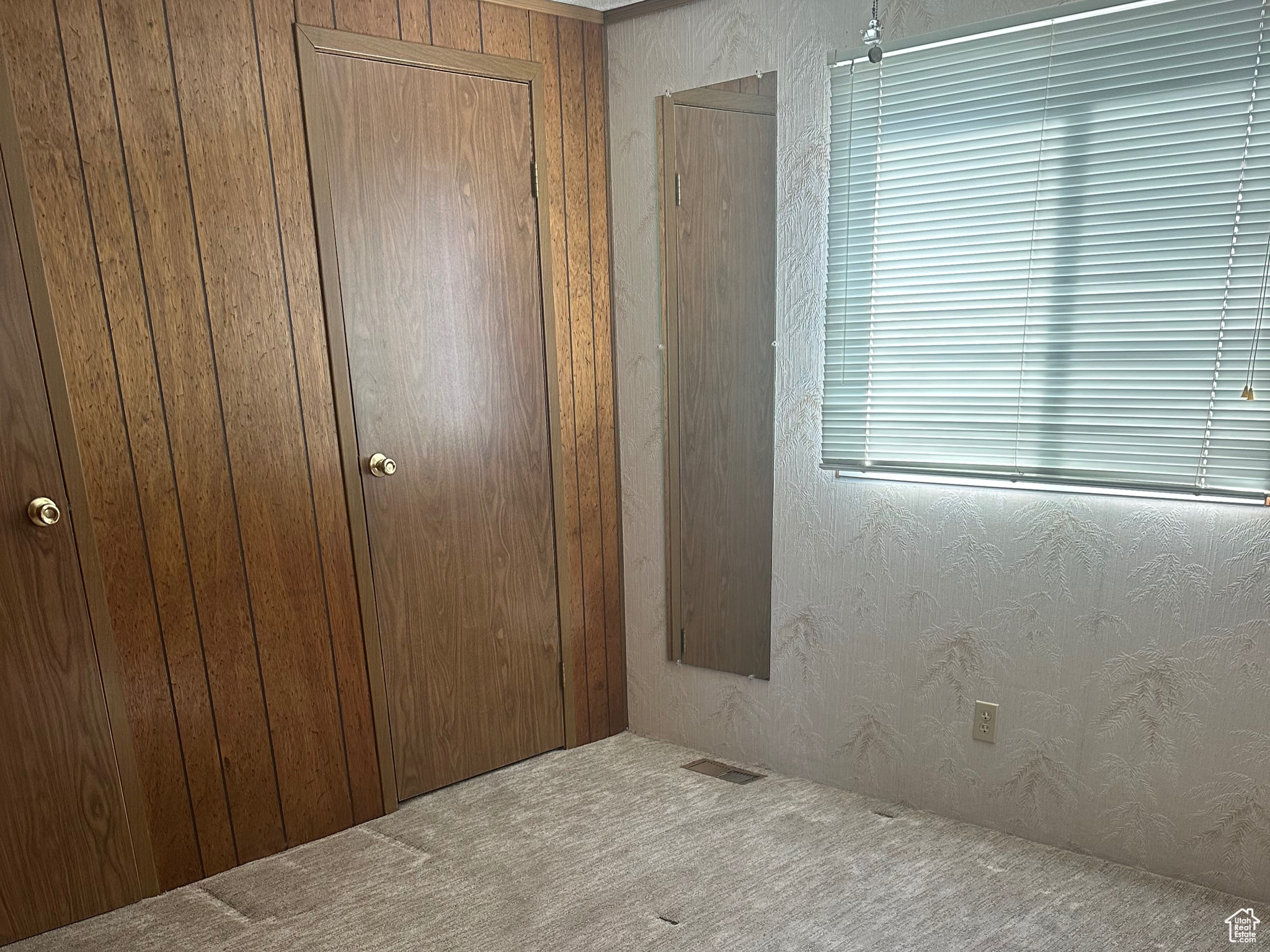 Unfurnished bedroom featuring visible vents, carpet floors, and a closet