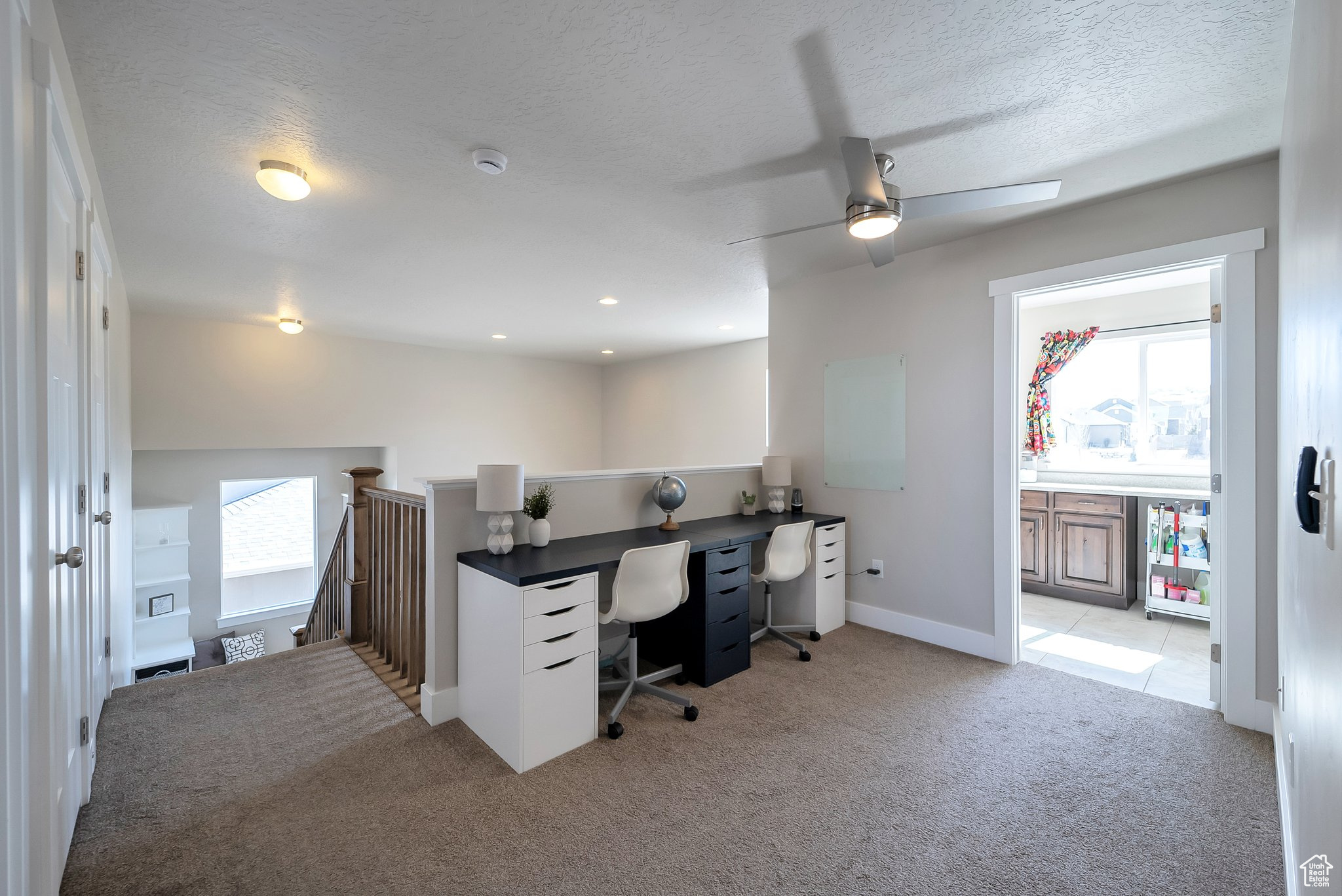 Home office featuring recessed lighting, baseboards, light colored carpet, and a textured ceiling