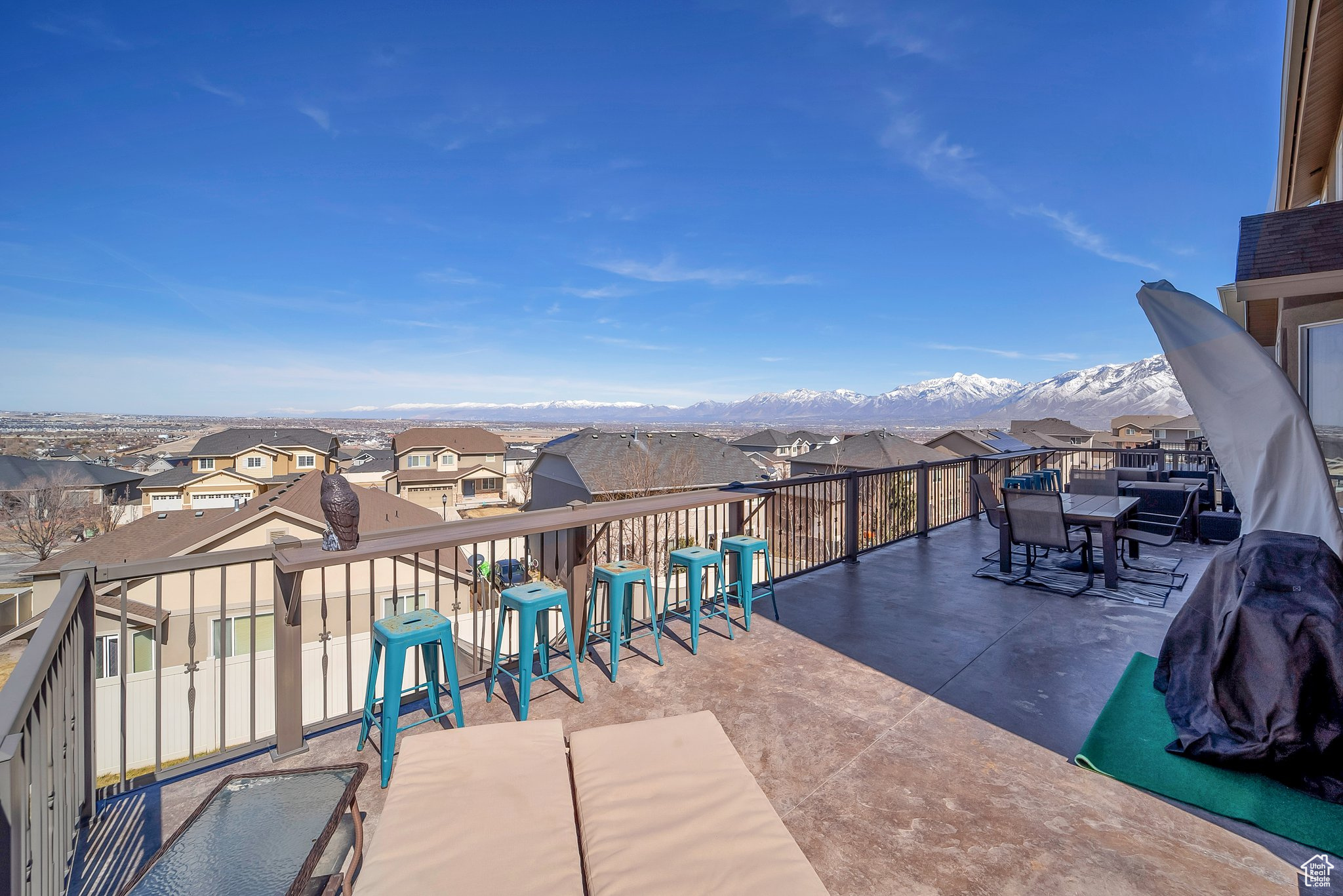 View of patio / terrace with a residential view, a mountain view, and a balcony