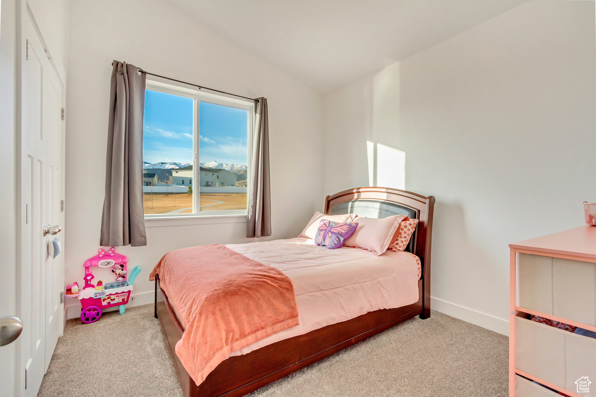 Bedroom with baseboards, carpet, and lofted ceiling