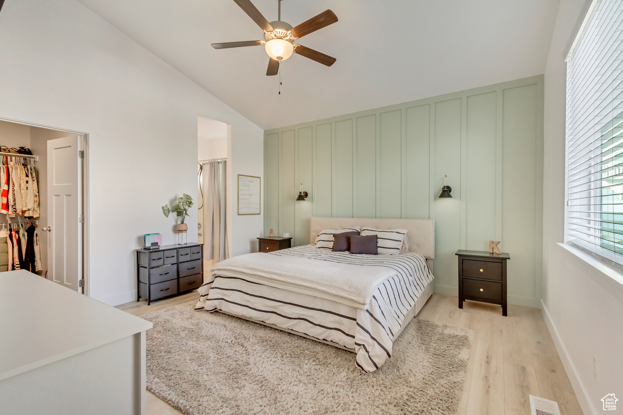 Bedroom with visible vents, light wood-style flooring, a closet, ceiling fan, and a spacious closet