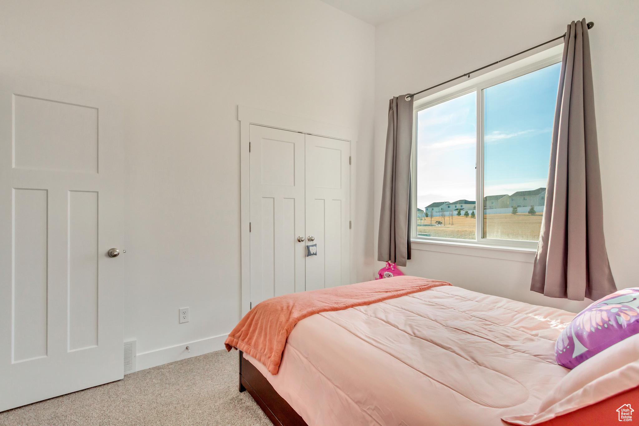 Bedroom featuring visible vents, carpet, a closet, and baseboards