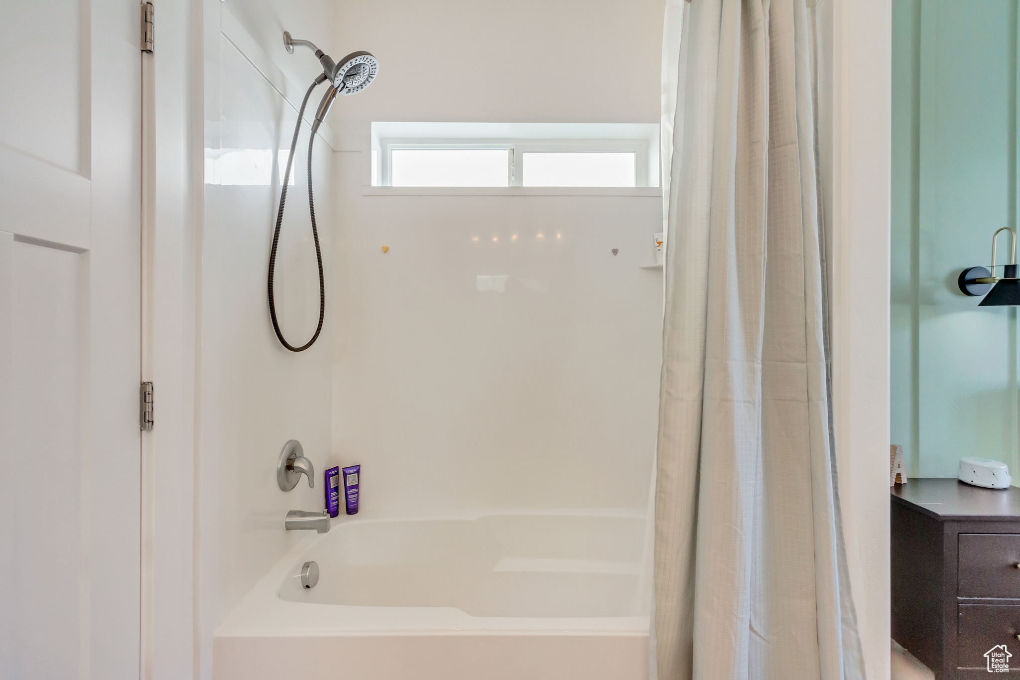 Bathroom featuring shower / tub combo with curtain