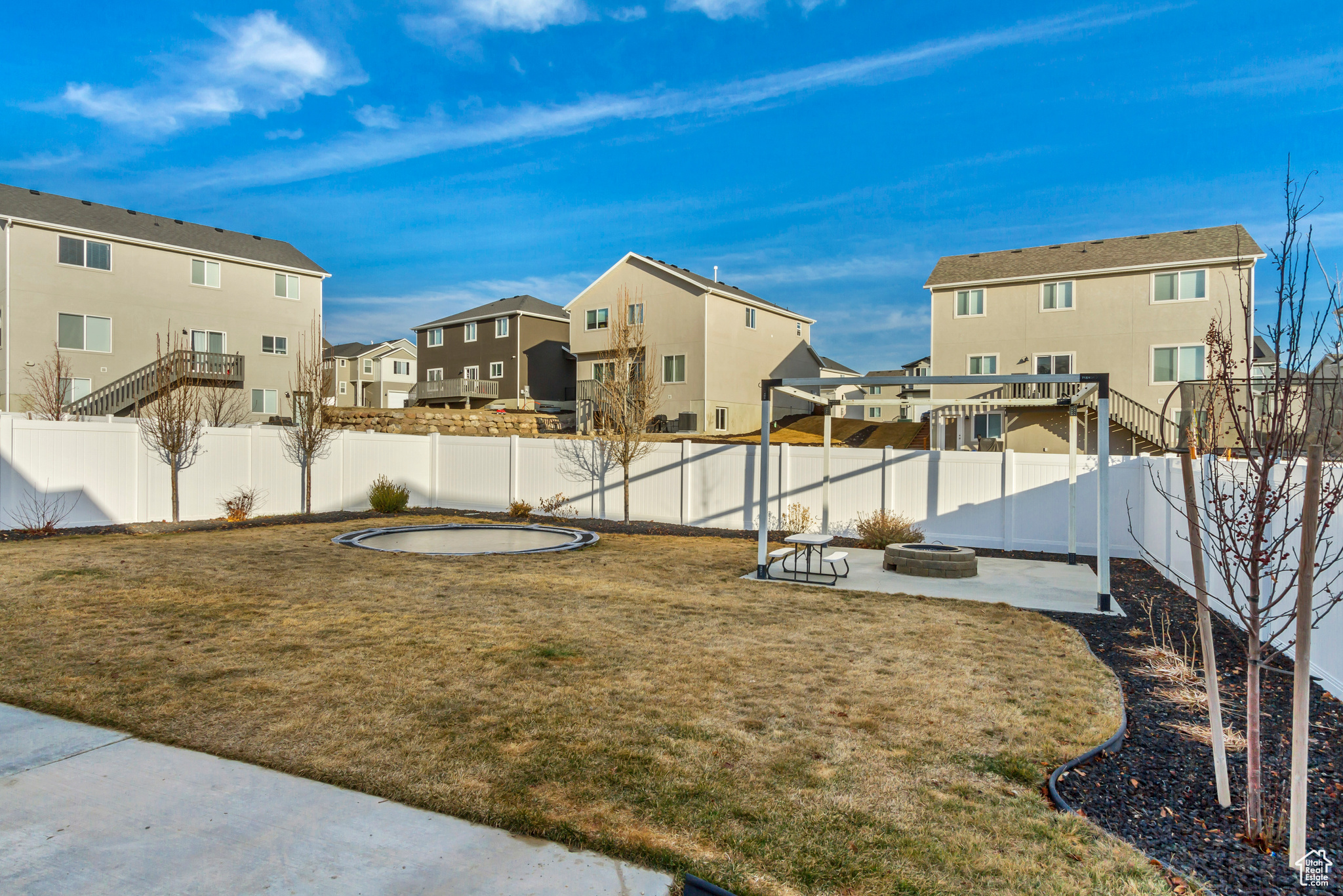 View of yard with a patio area, a residential view, a fenced backyard, and an outdoor fire pit