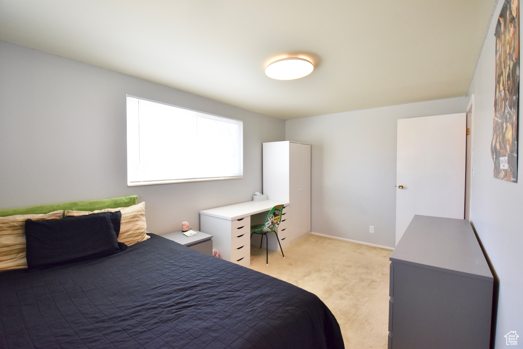 Bedroom featuring light colored carpet