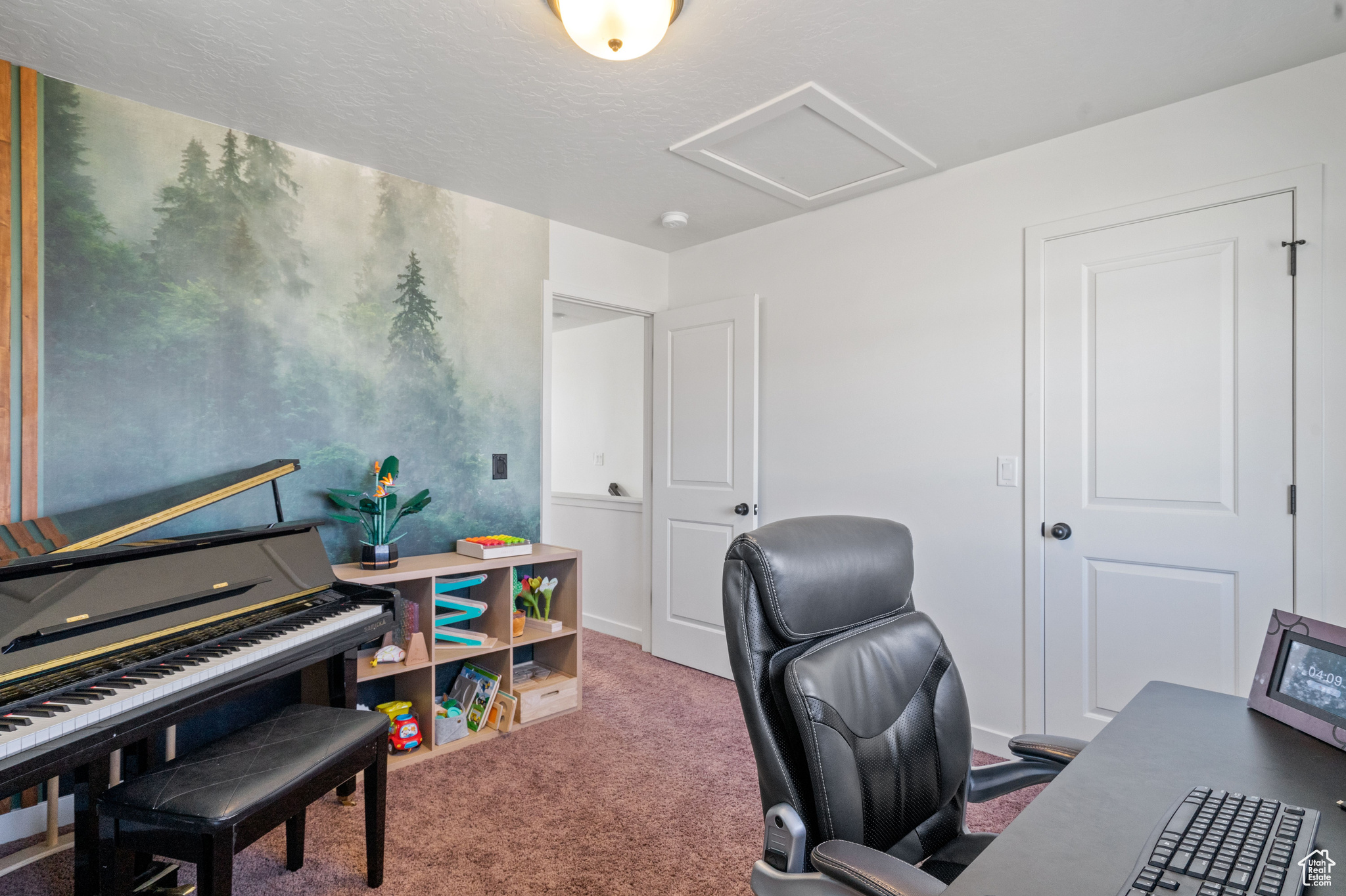 Carpeted office with attic access