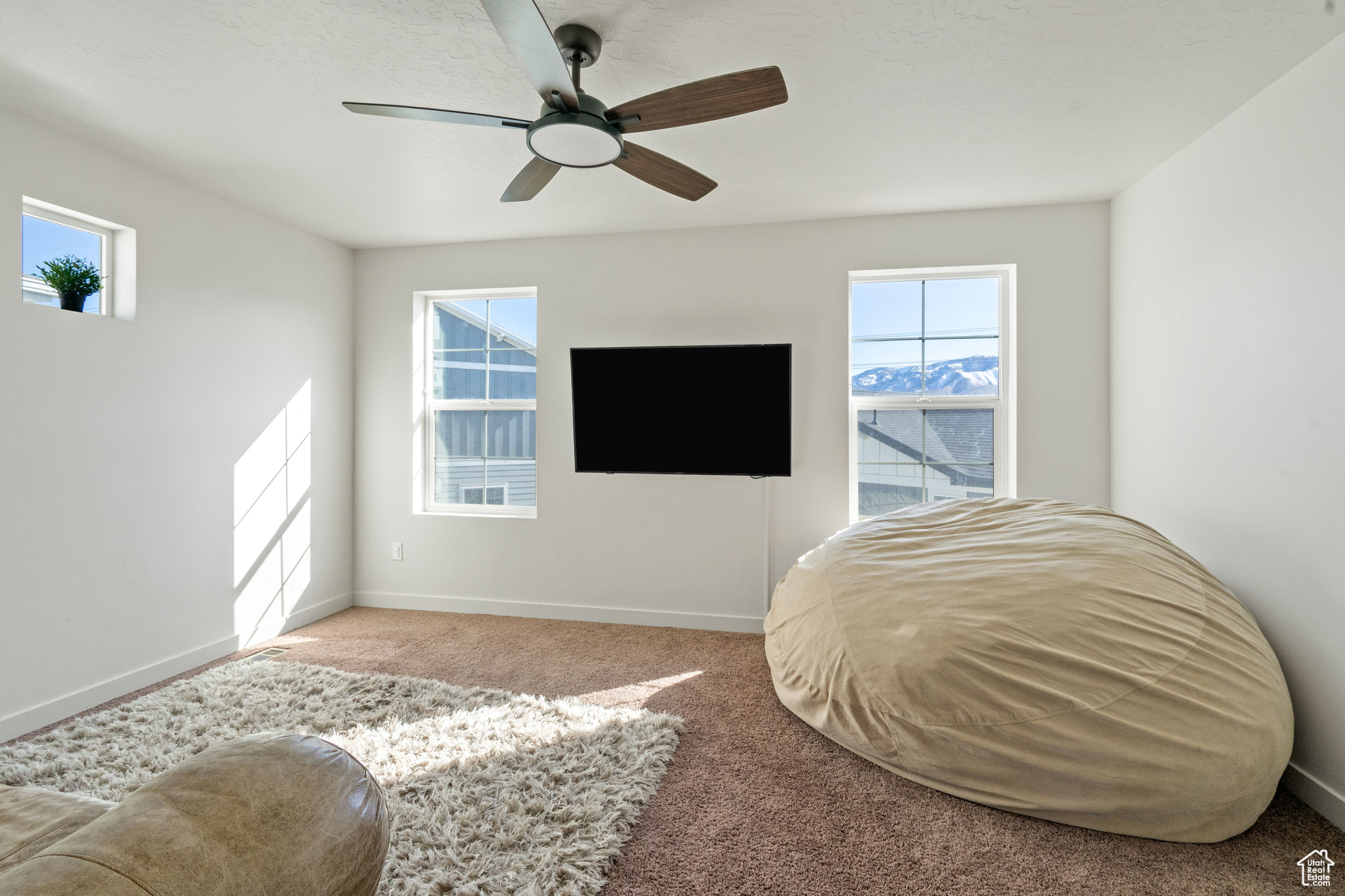 Bedroom featuring ceiling fan, carpet, and baseboards