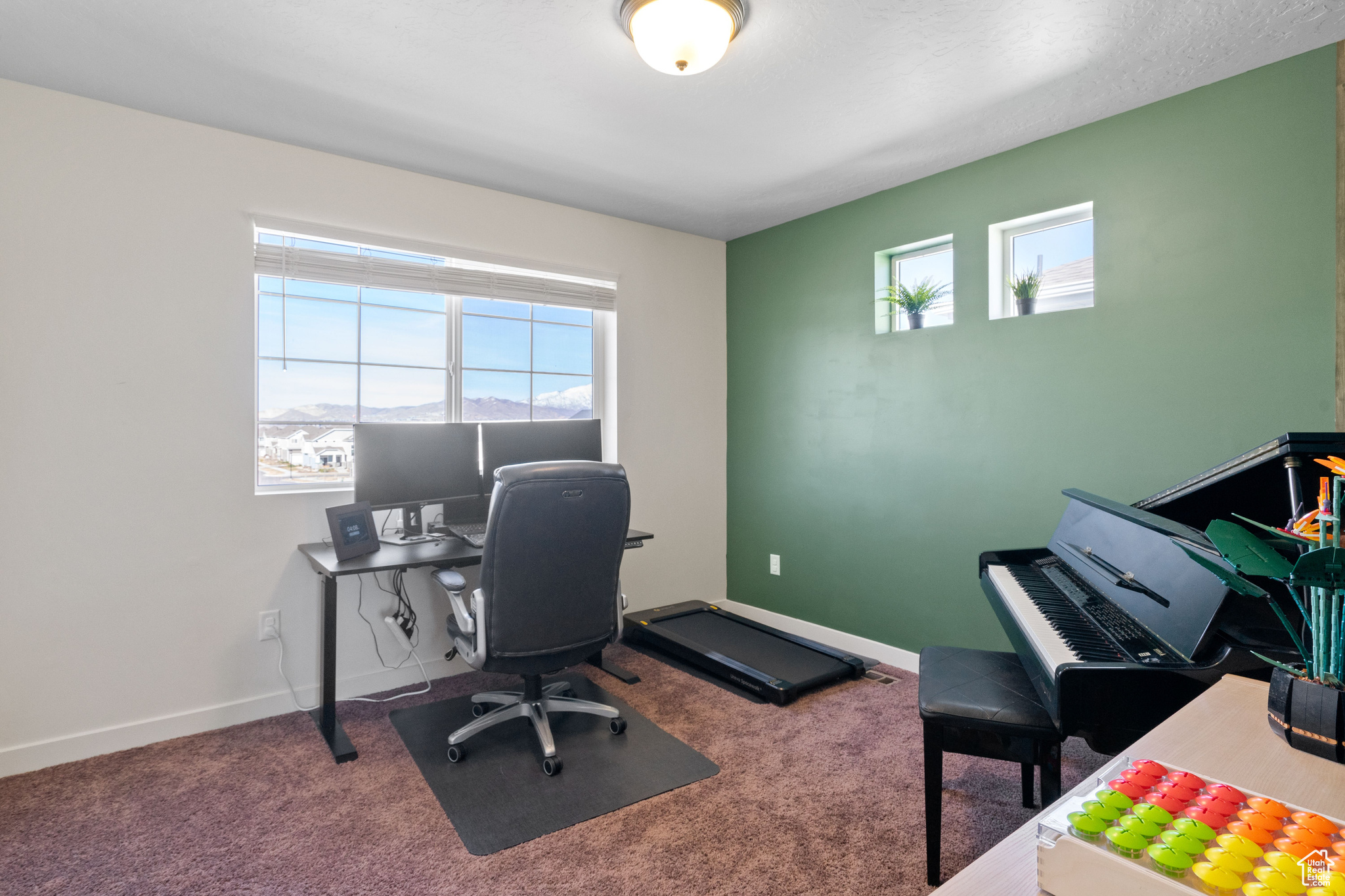 Office space with baseboards and carpet flooring