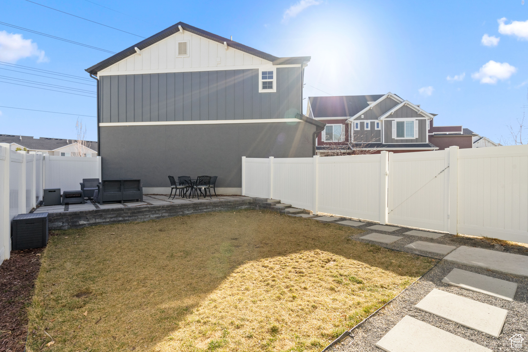 Exterior space featuring a patio, a gate, and a fenced backyard
