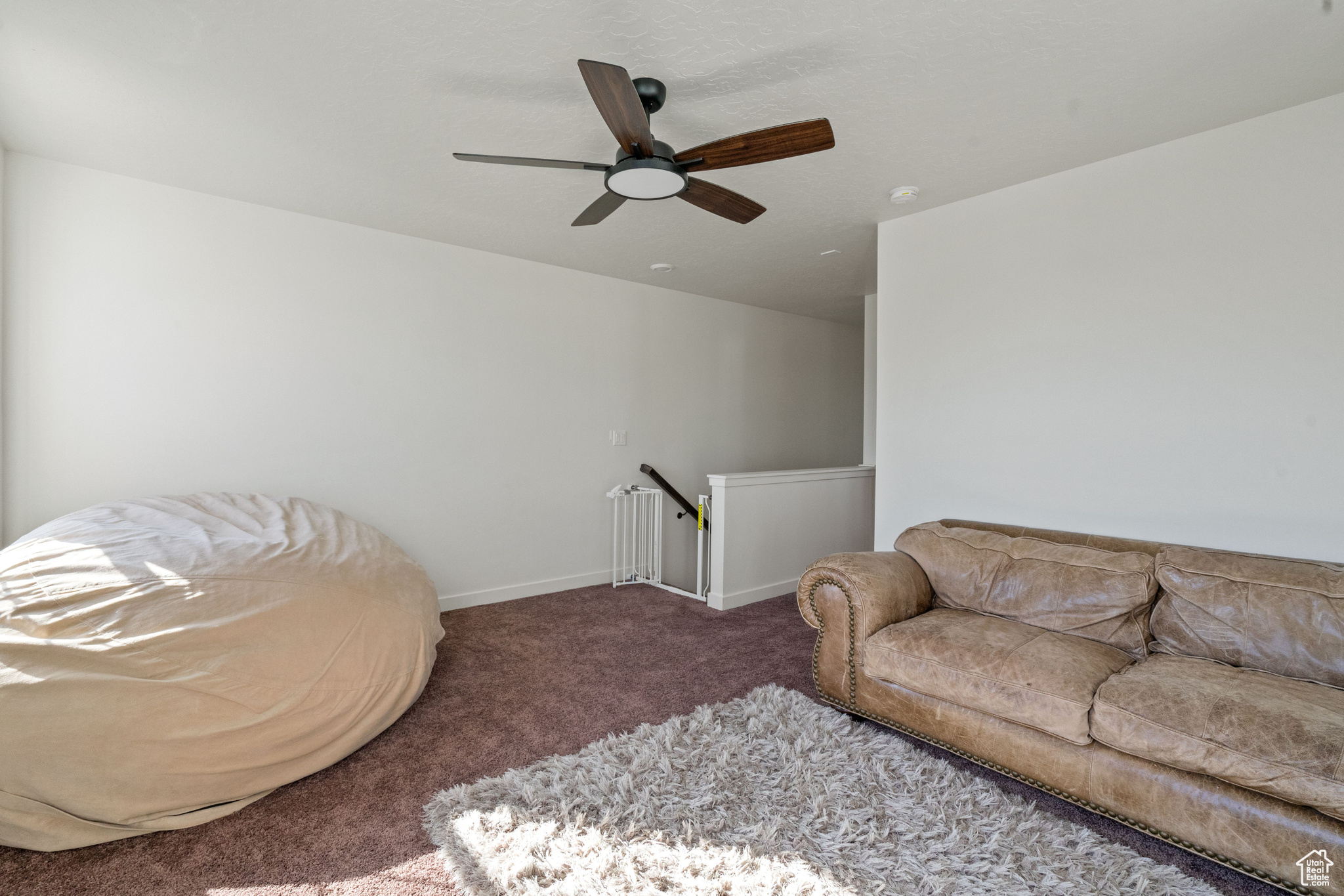 Living room featuring baseboards and carpet