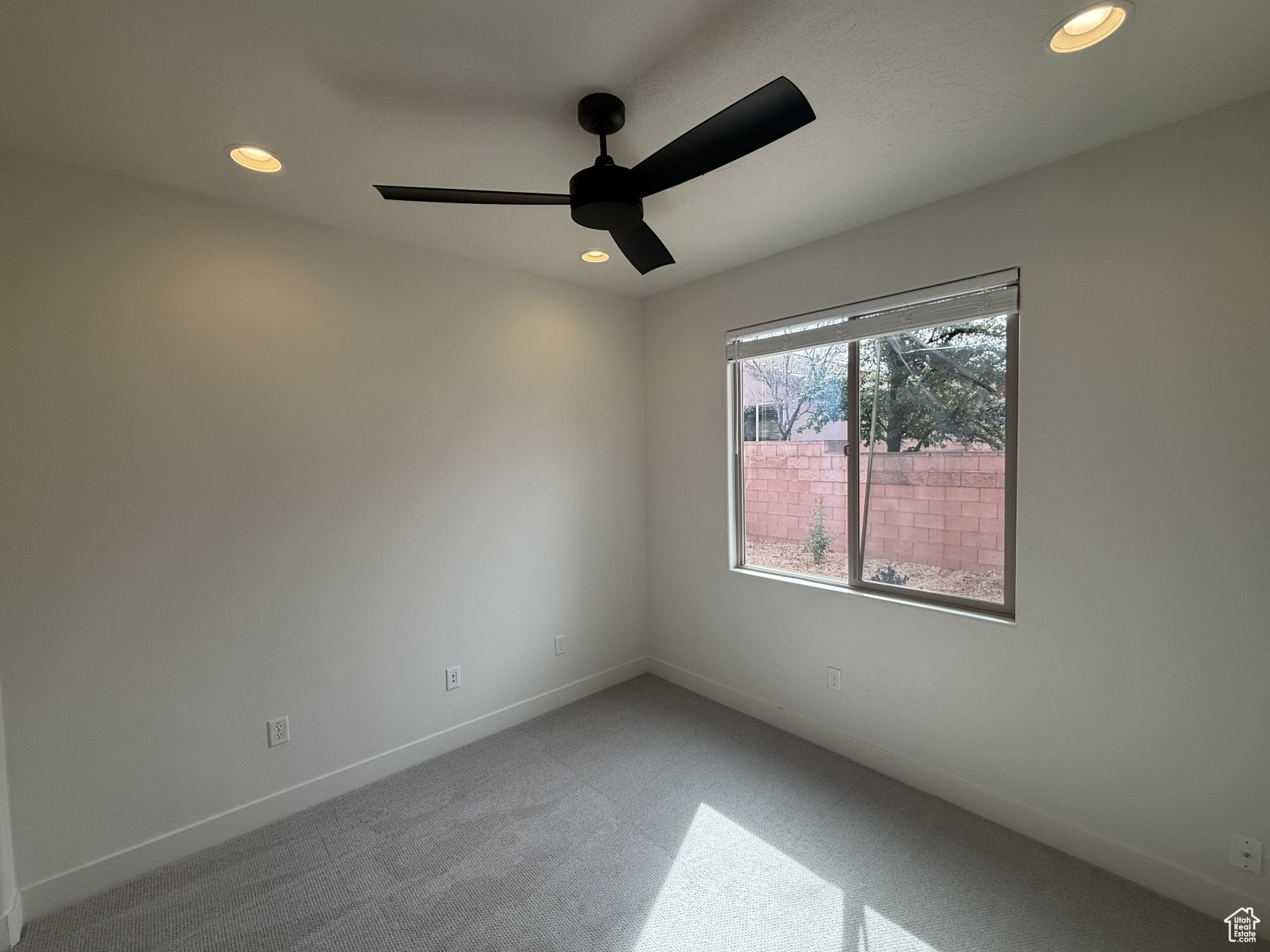 Spare room with recessed lighting, light colored carpet, baseboards, and ceiling fan