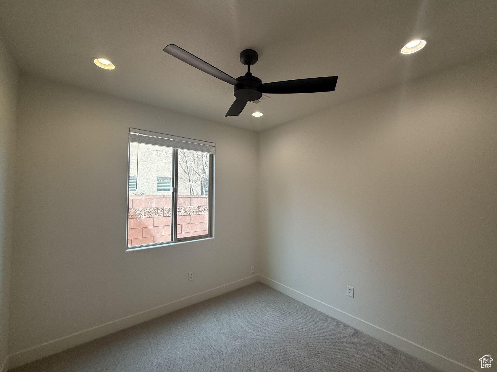 Unfurnished room featuring light carpet, recessed lighting, baseboards, and ceiling fan