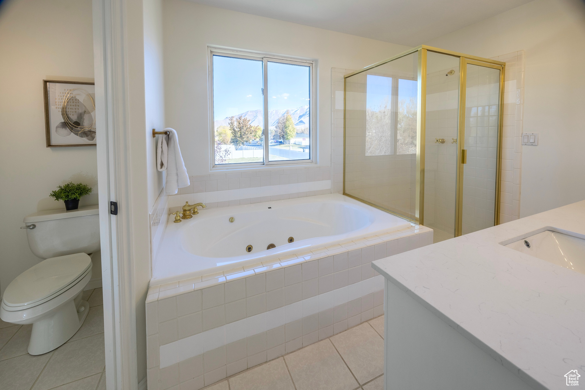 Full bathroom with a stall shower, toilet, a tub with jets, tile patterned floors, and vanity