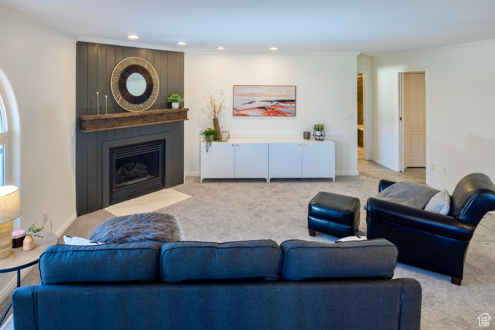 Living area featuring light carpet, baseboards, ornamental molding, a fireplace, and recessed lighting