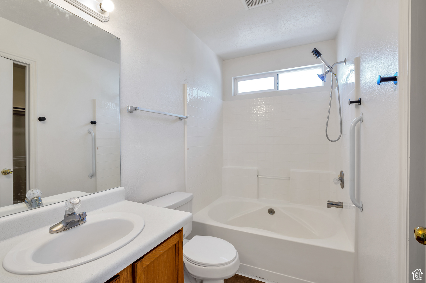 Full bath featuring shower / tub combination, visible vents, toilet, and vanity