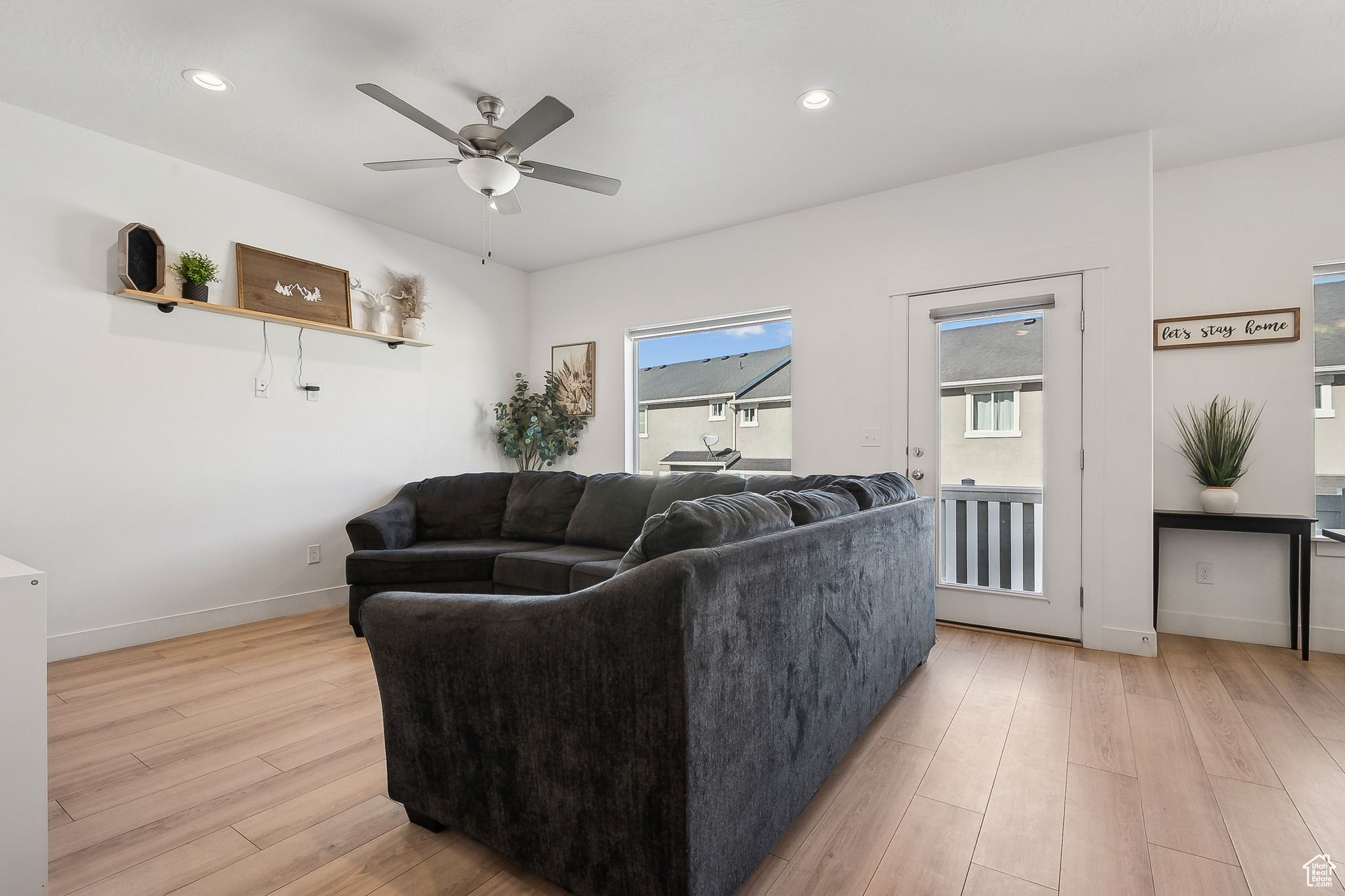 Living area with light wood-style floors, recessed lighting, baseboards, and a ceiling fan