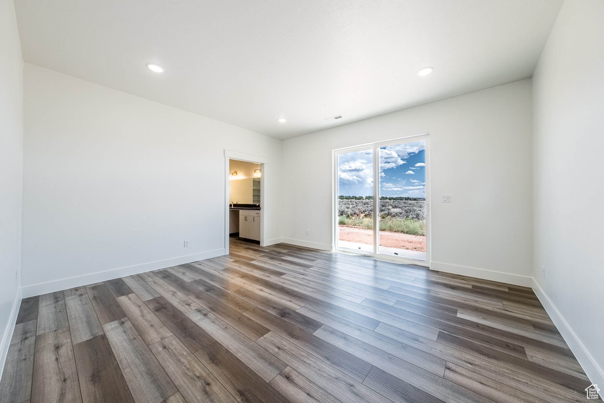 Unfurnished room featuring recessed lighting, wood finished floors, and baseboards