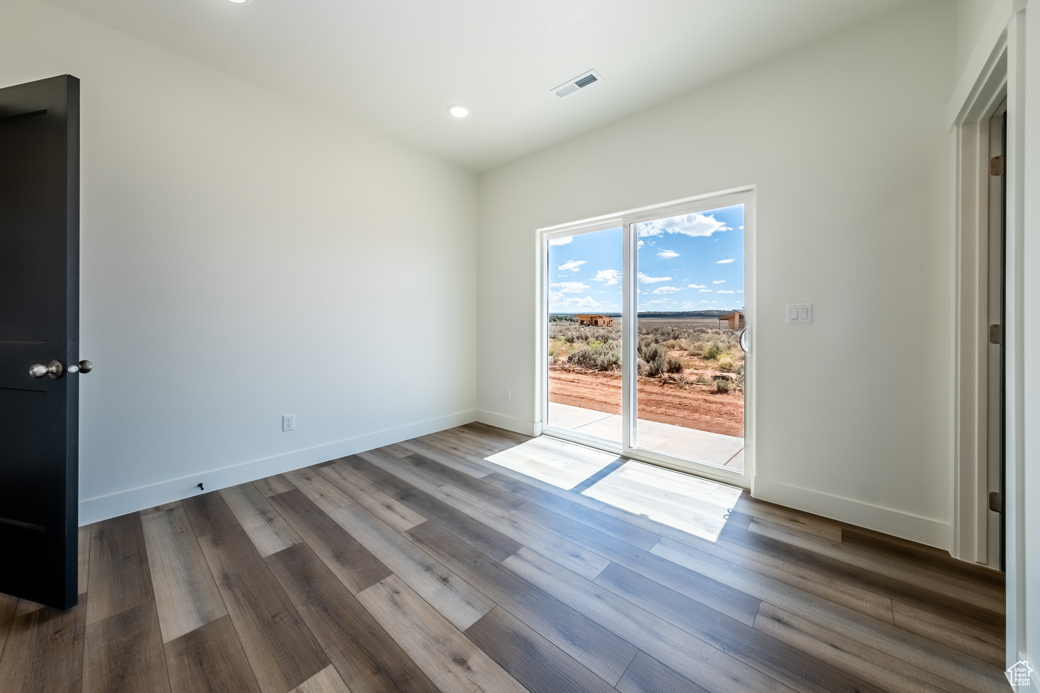 Spare room with recessed lighting, visible vents, baseboards, and wood finished floors