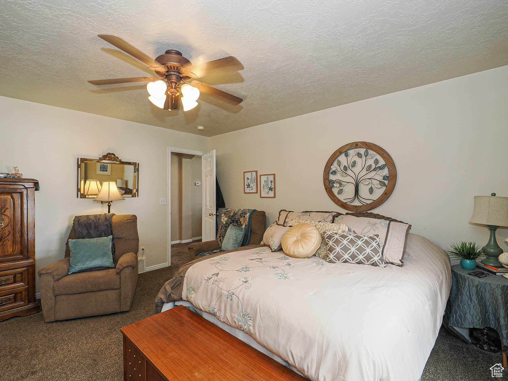 Bedroom with baseboards, a textured ceiling, a ceiling fan, and carpet floors