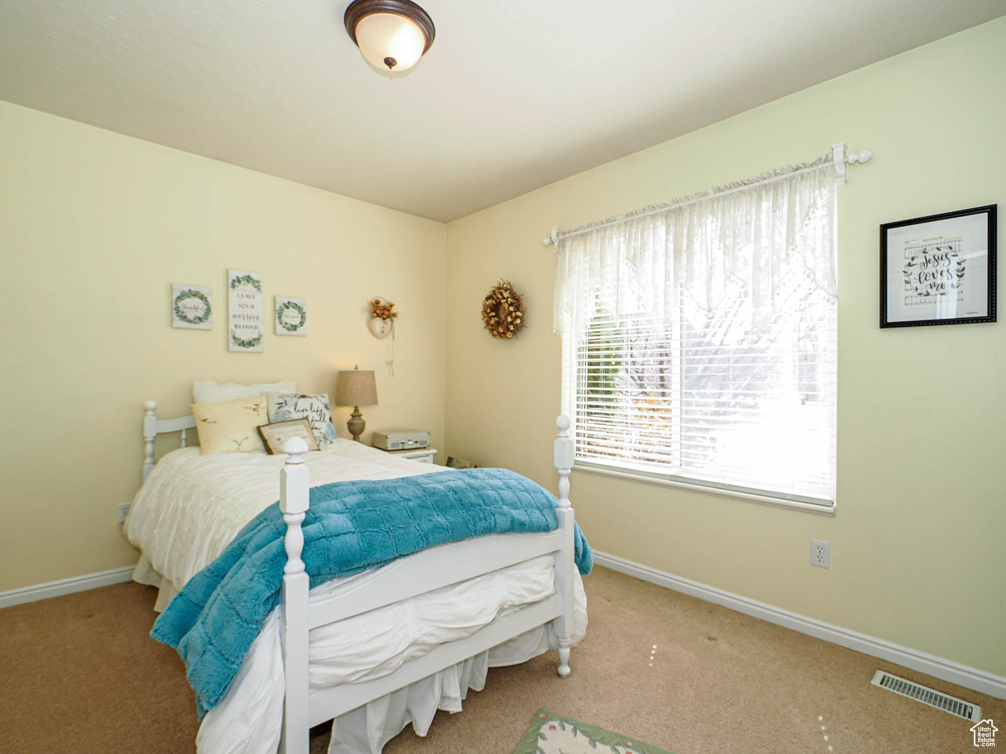 Carpeted bedroom featuring visible vents and baseboards
