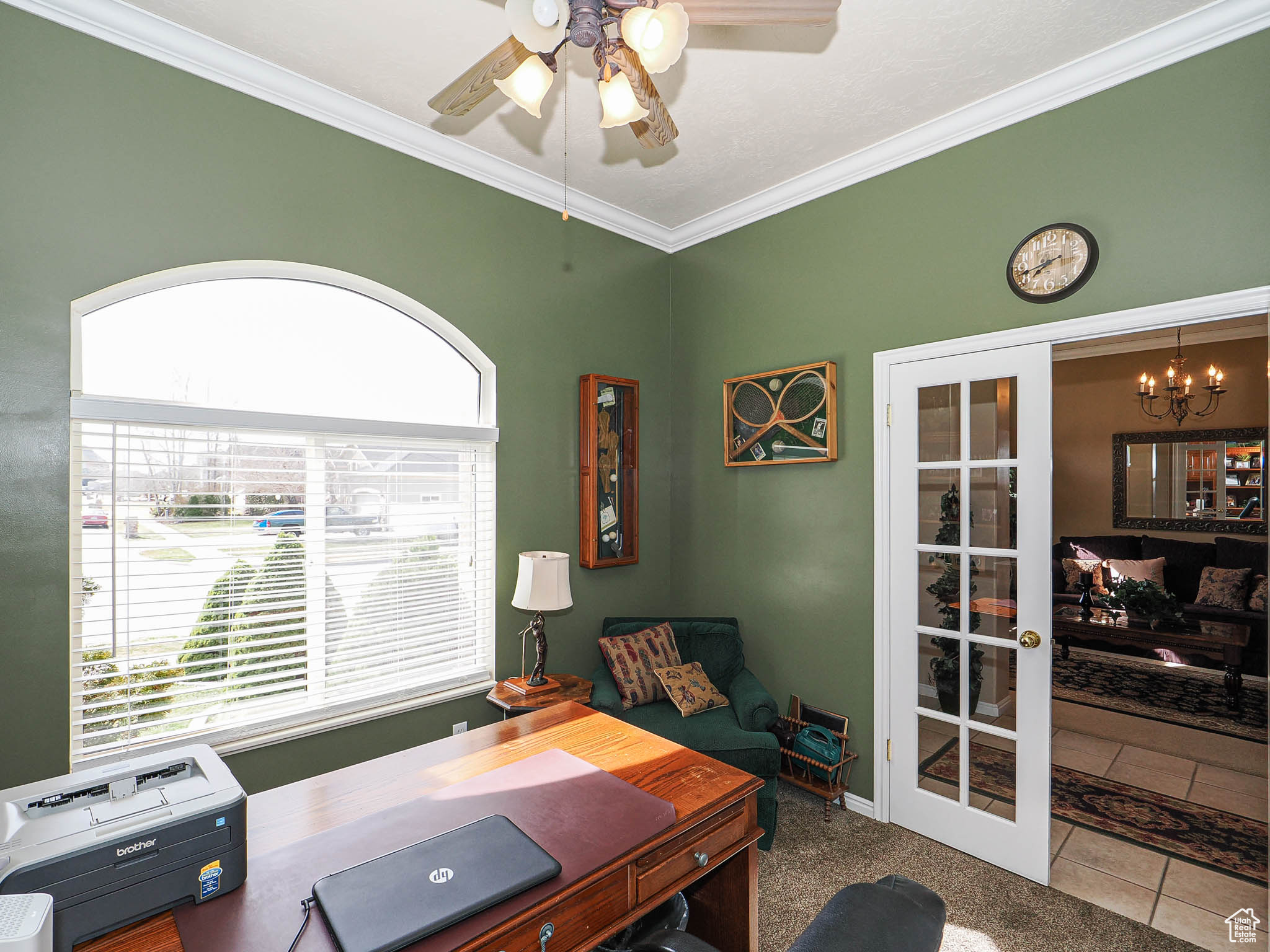 Office area featuring tile patterned flooring, ceiling fan with notable chandelier, french doors, and ornamental molding