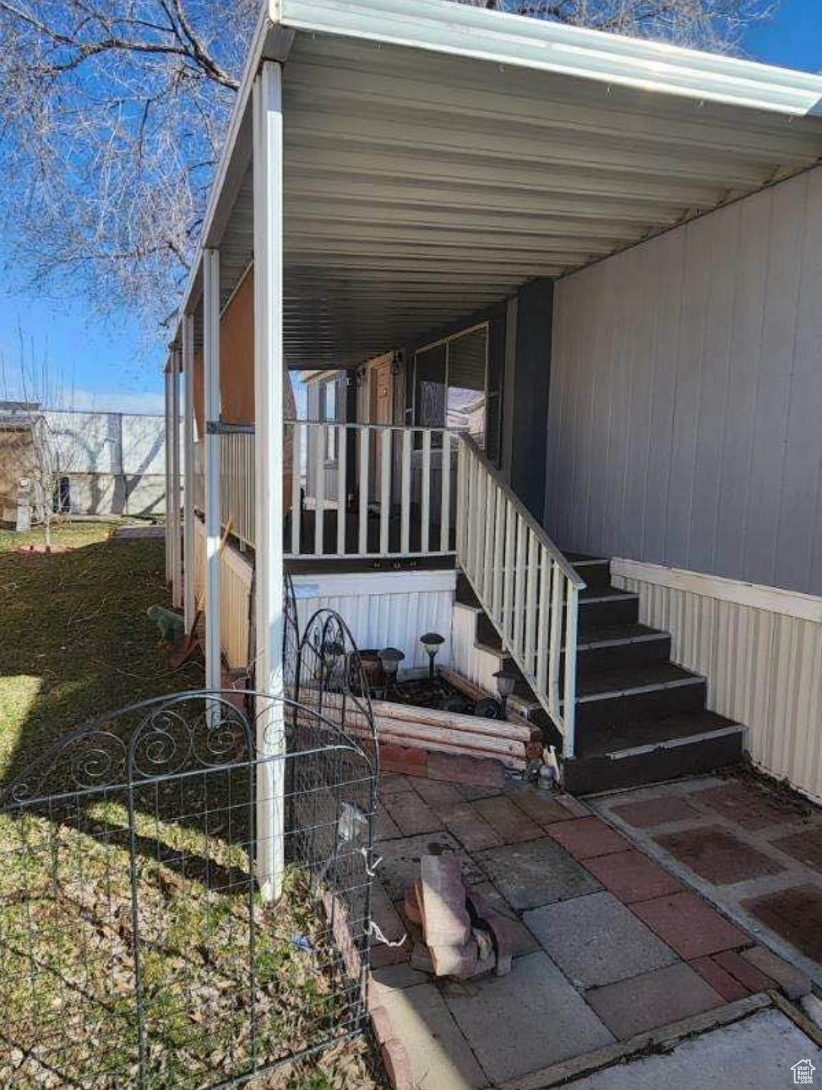 Doorway to property featuring a carport