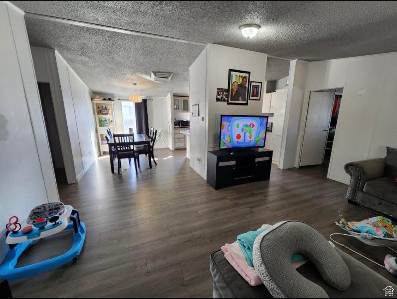 Living room with dark wood-style floors and a textured ceiling