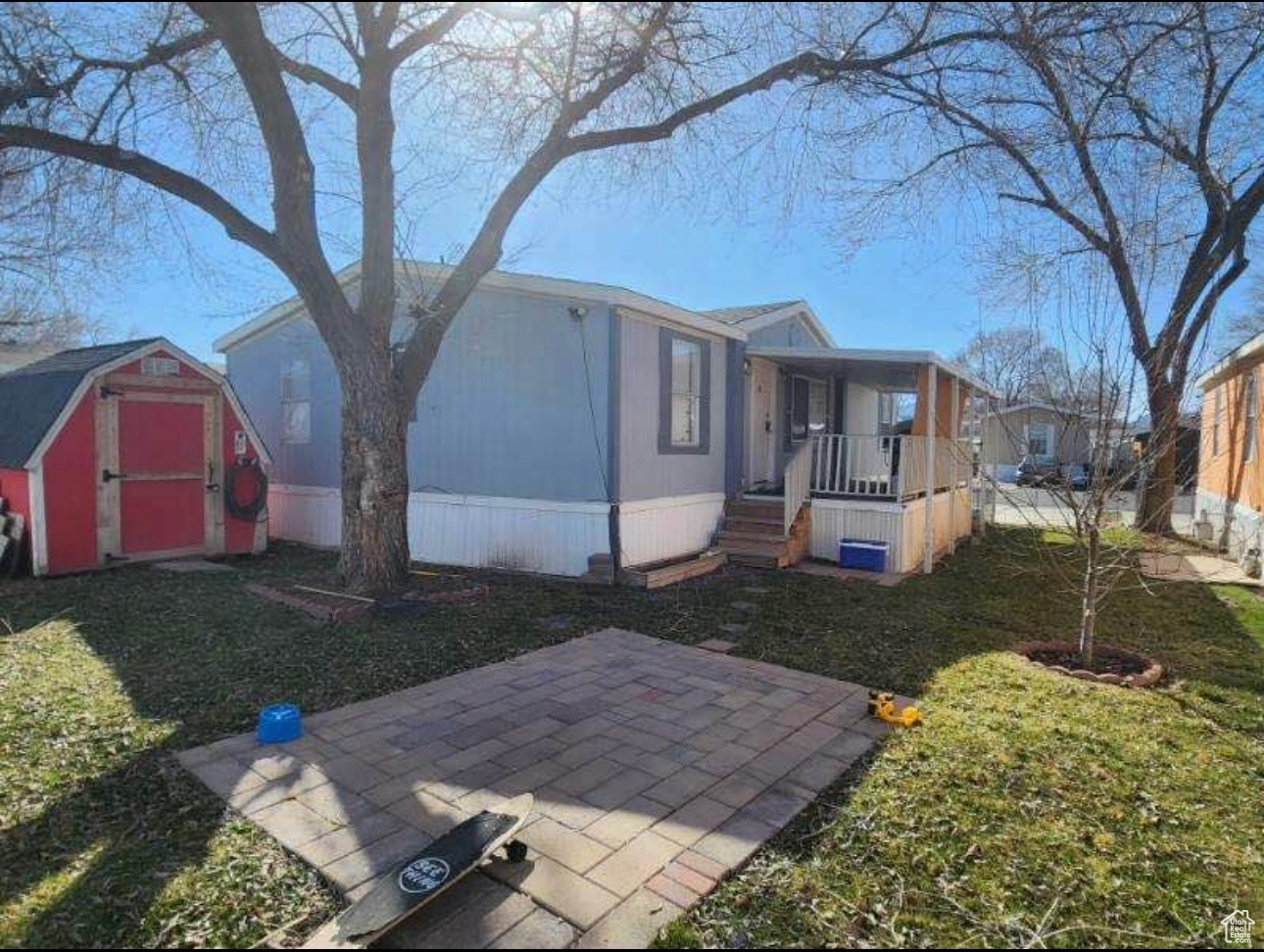 Exterior space with an outbuilding, covered porch, and a storage shed