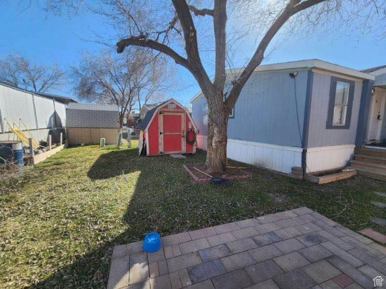 View of yard with an outbuilding and a storage shed