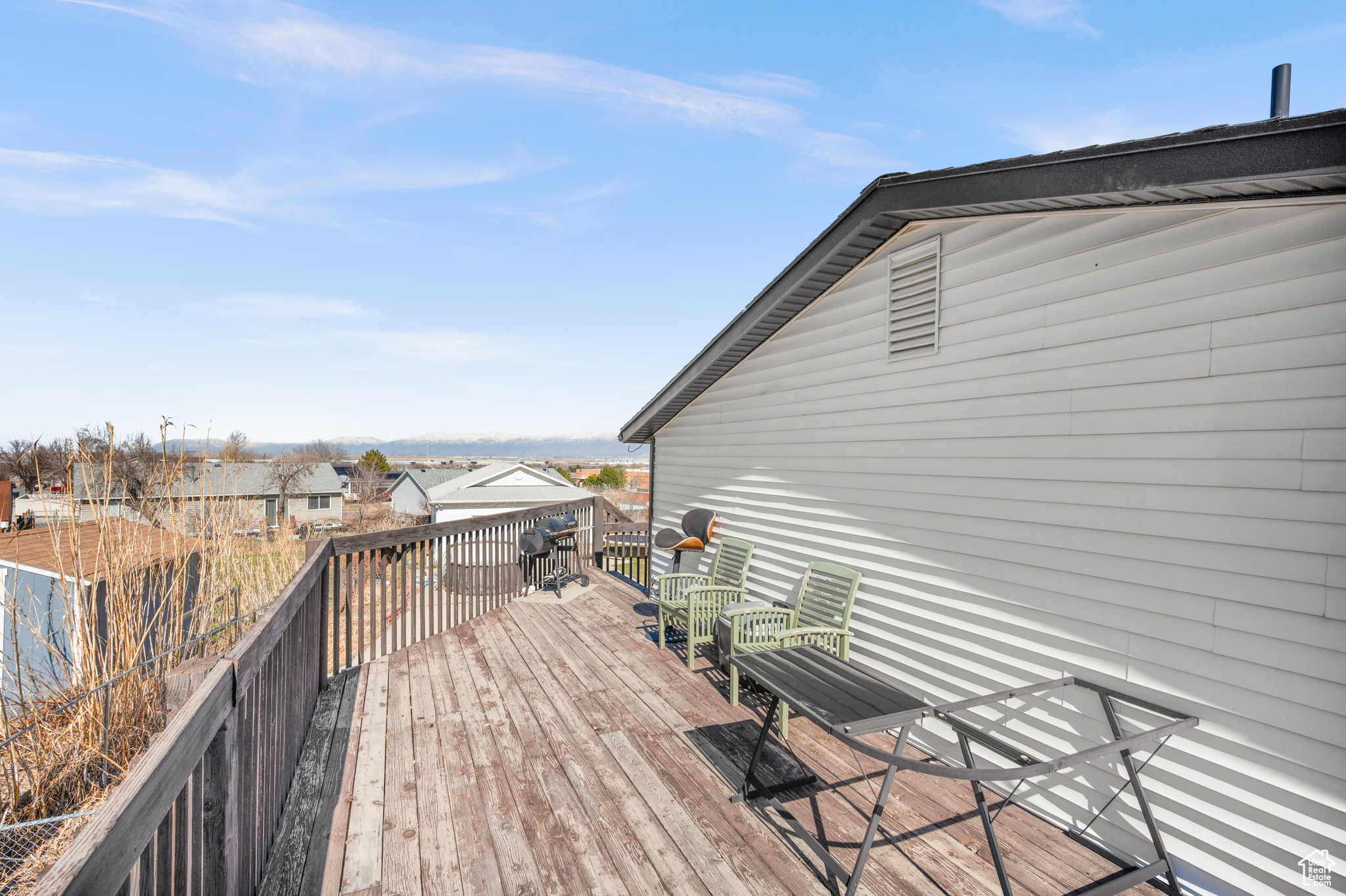 Wooden terrace featuring a residential view