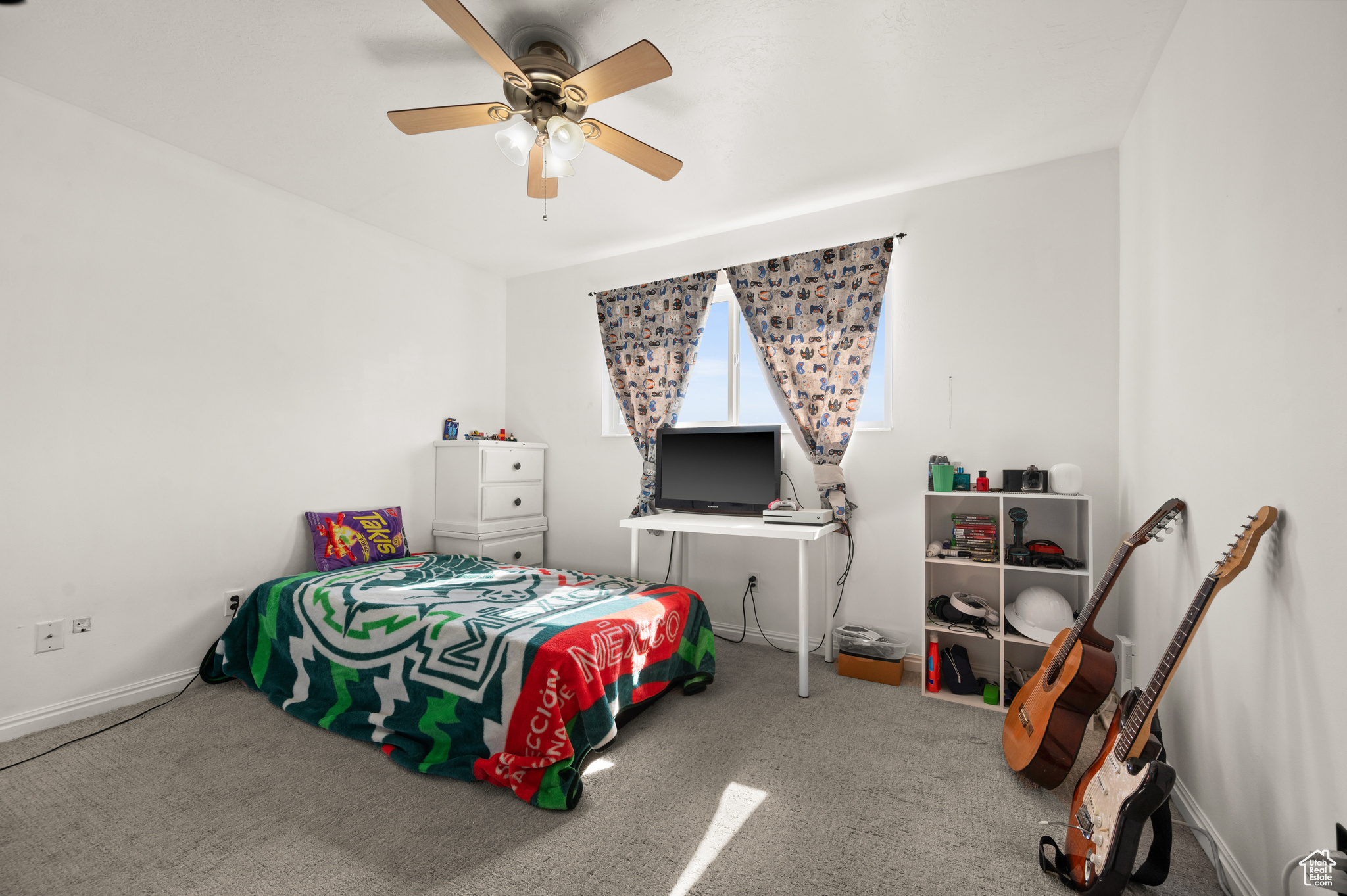 Bedroom with baseboards, carpet, and ceiling fan