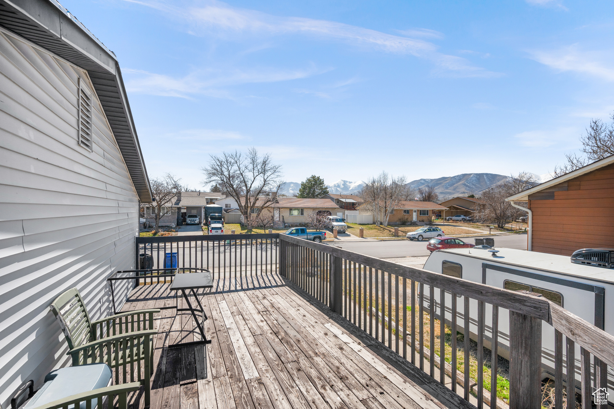 Wooden deck featuring a residential view and a mountain view