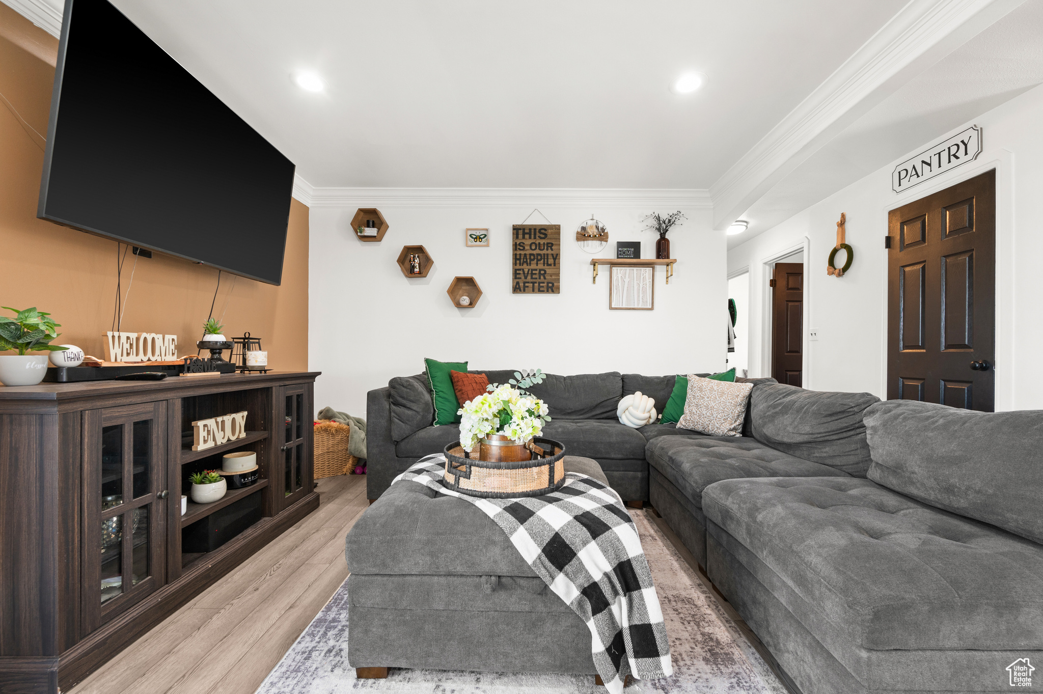 Living area featuring recessed lighting, light wood-type flooring, and ornamental molding