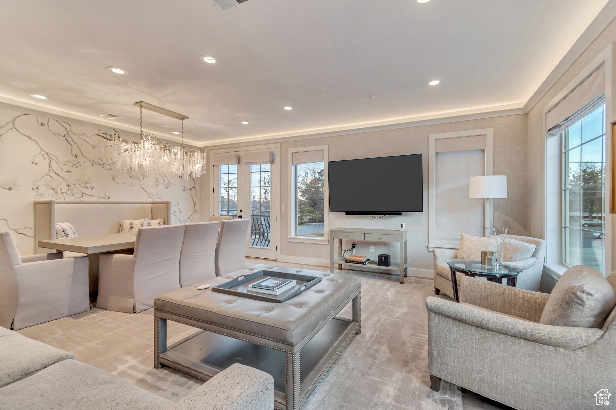 Living room with a notable chandelier and recessed lighting