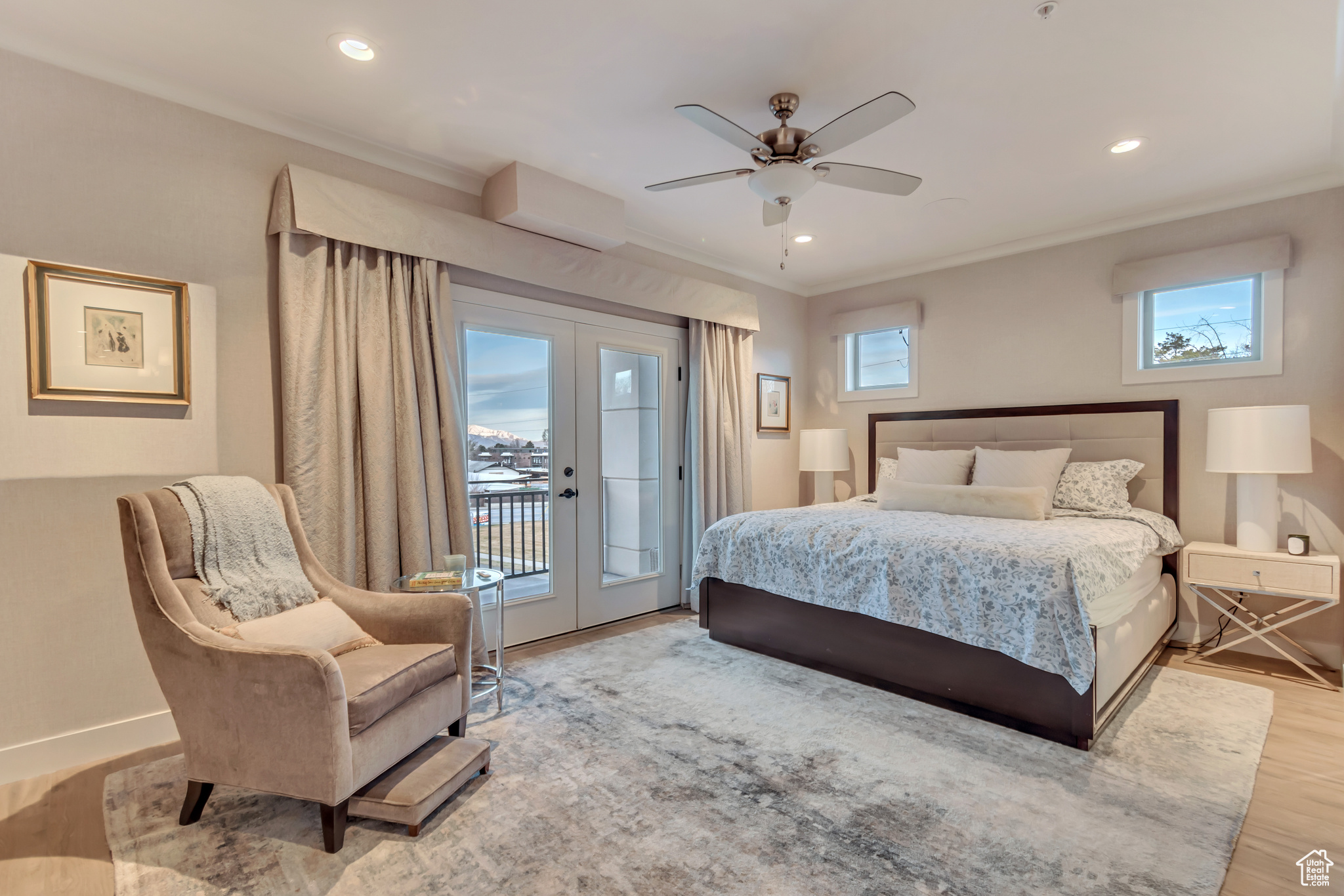 Bedroom with access to exterior, multiple windows, wood finished floors, and french doors