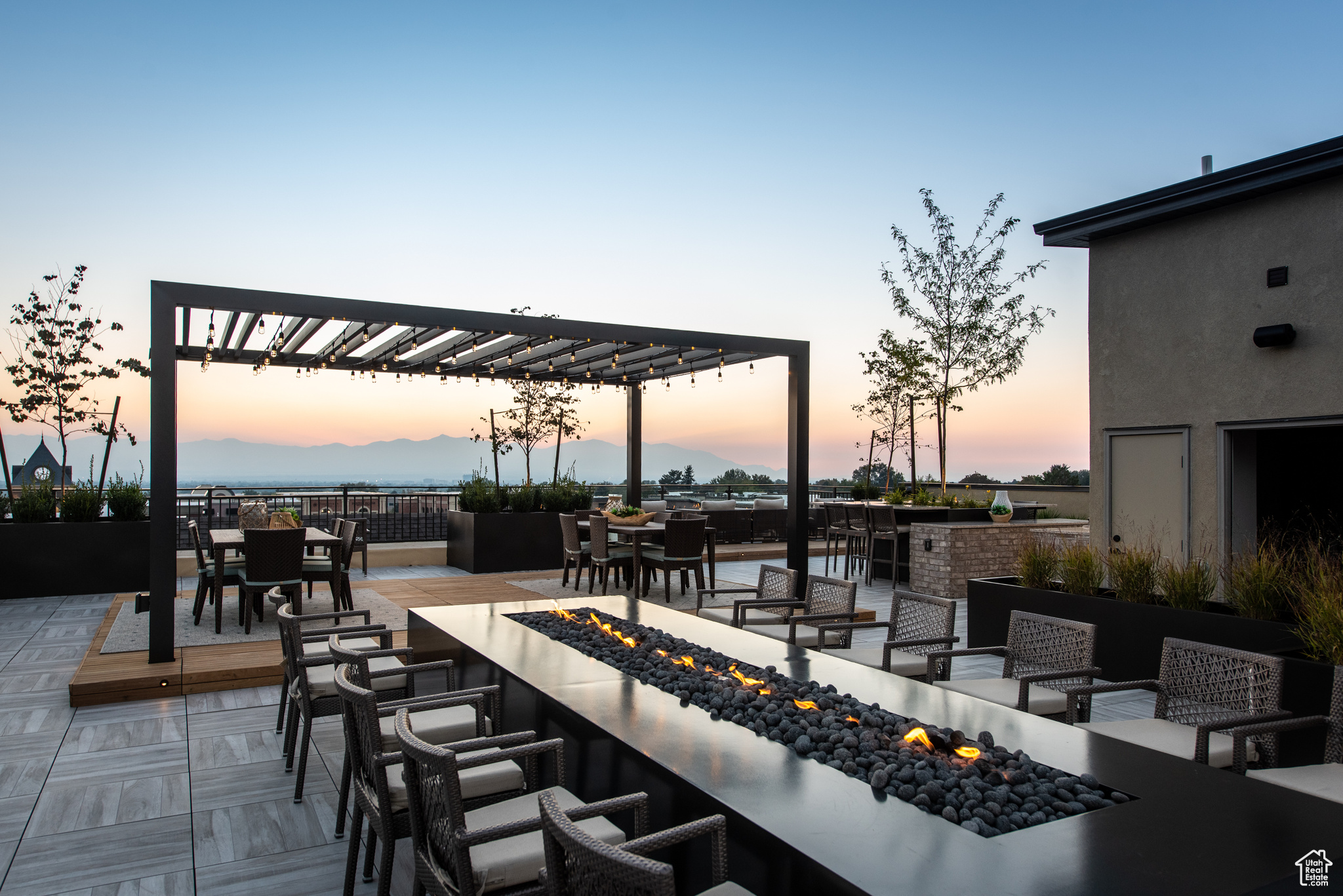 View of patio featuring outdoor dining space, a pergola, and an outdoor living space with a fire pit